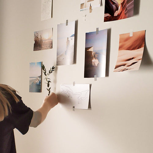 Person designing and planning a gallery wall with art Person designing and planning a gallery wall with art